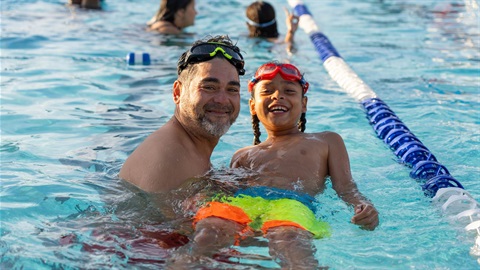 Man and child in pool