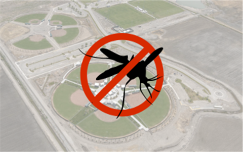 Baseball fields behind an image of a mosquito with a red line through it