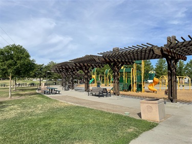 wooden shade structure in front of playground