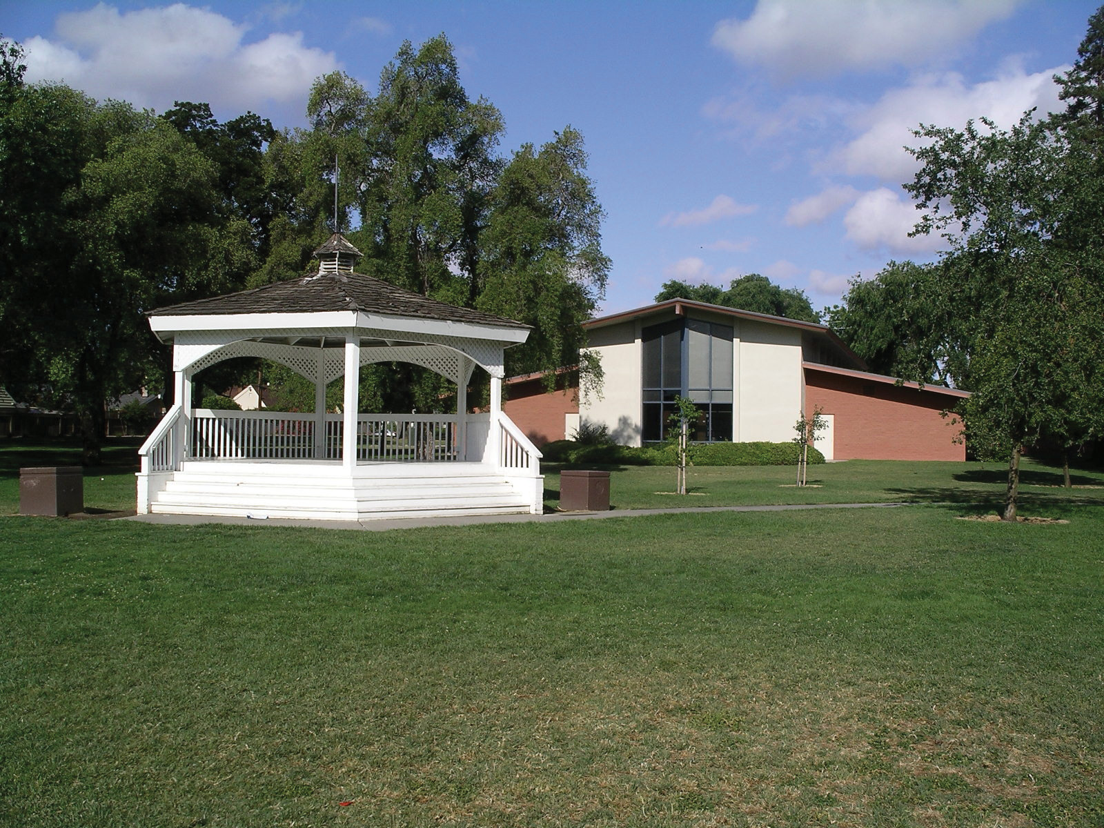 Library building with gazebo in front and a grassy area