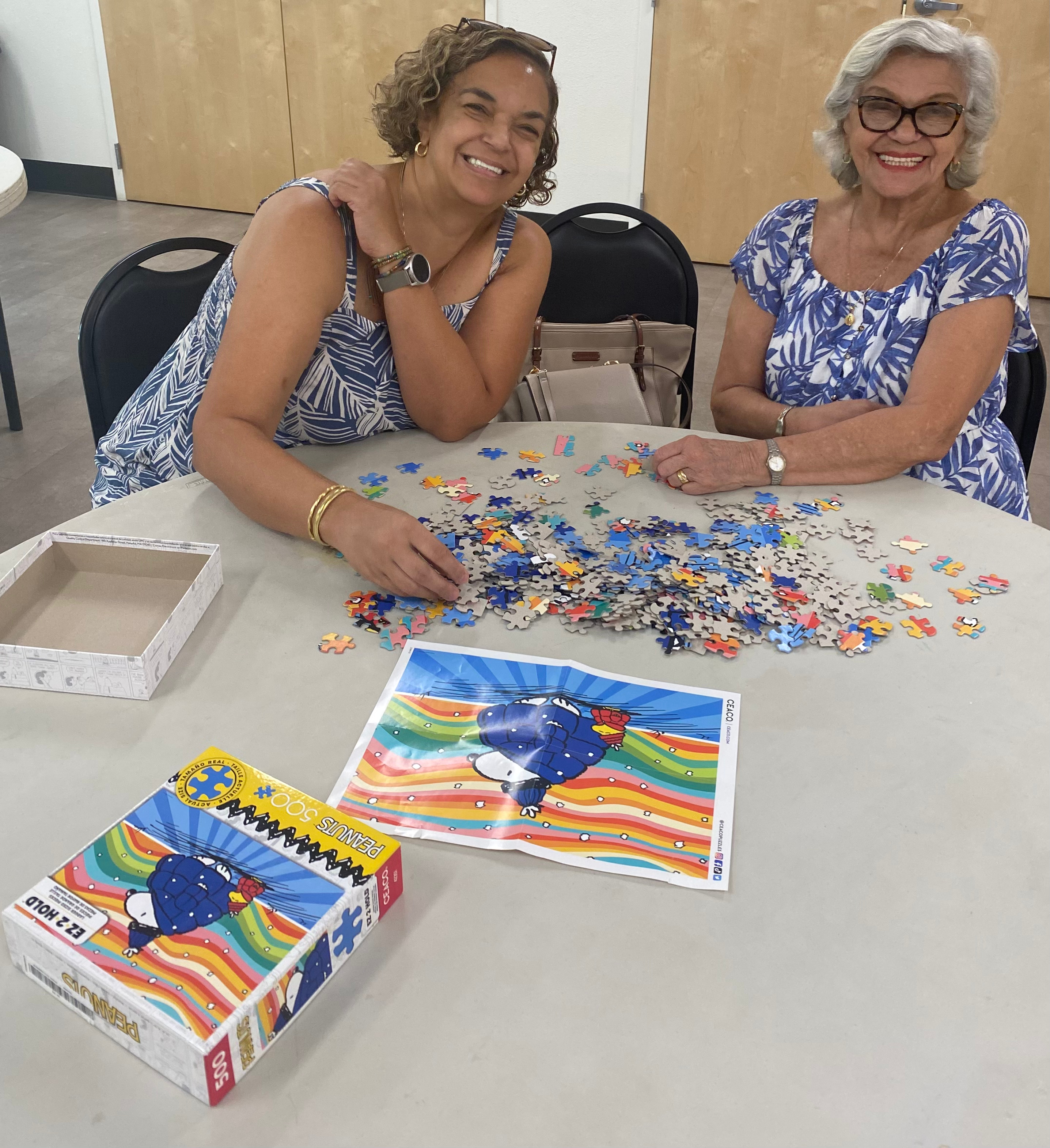 Two seniors work on a puzzle activity